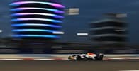 Visa Cash APP Racing Bulls Team vehicle on the rice track with buildings on the back Visa Cash APP Racing Bulls Team vehicle on the rice track with buildings on the back