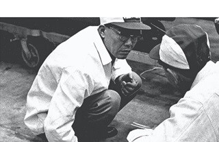 Sochiro Honda conferring with two other Honda workers.