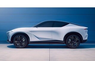 2024 Acura Performance EV Concept Moonlit White Pearl profile view against a blue wall. (Acura Performance EV Concept)