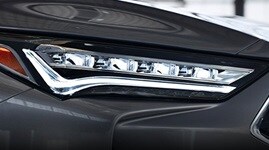 2022 Acura MDX FWD in Liquid Carbon Metallic with closeup of the Jewel Eye LED headlights (Premium Performance SUV).