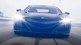 Monochrome front-end close-up of NSX on racetrack.