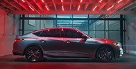2023 Integra A-Spec in Liquid Carbon Metallic with accessories, profile view in a garage with red lighting 2023 Integra A-Spec in Liquid Carbon Metallic with accessories, profile view in a garage with red lighting