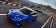 Two 2023 Integra in Apex Blue Pearl and Liquid Carbon Metallic driving in a highway Two 2023 Integra in Apex Blue Pearl and Liquid Carbon Metallic driving in a highway