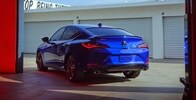2023 Integra in Apex Blue Pearl driving out of warehouse rear view 2023 Integra in Apex Blue Pearl driving out of warehouse rear view