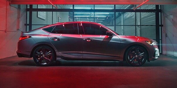2023 Integra A-Spec in Liquid Carbon Metallic with accessories, profile view in a garage with red lighting  2023 Integra A-Spec in Liquid Carbon Metallic with accessories, profile view in a garage with red lighting