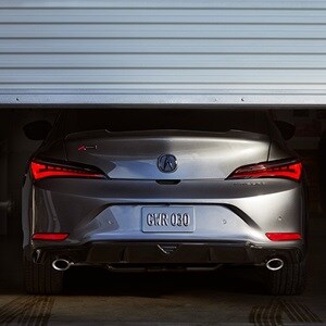 2023 Integra A-Spec in Liquid Carbon Metallic with accessories, rear view in a garage 2023 Integra A-Spec in Liquid Carbon Metallic with accessories, rear view in a garage