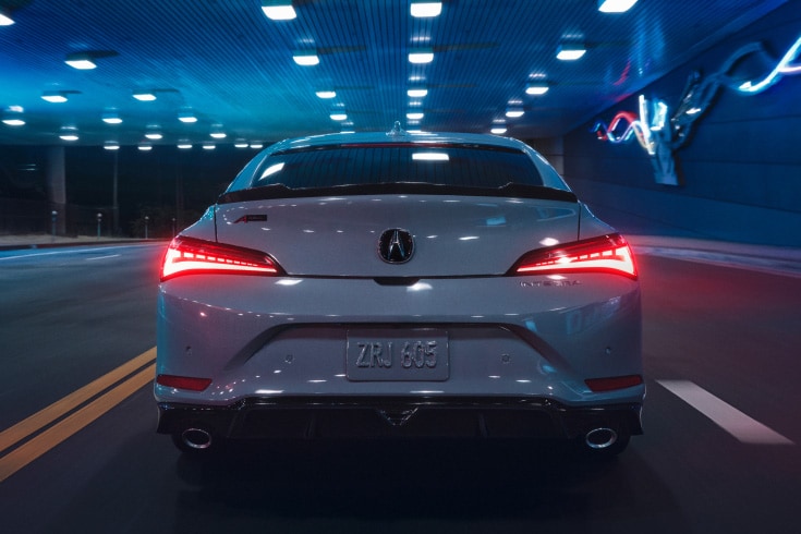 2026 Acura Integra A-Spec with Technology Package in Urban Gray Pearl, driving in a neon-lit tunnel (Premium Sport Compact). 2026 Acura Integra A-Spec with Technology Package in Urban Gray Pearl, driving in a neon-lit tunnel (Premium Sport Compact).