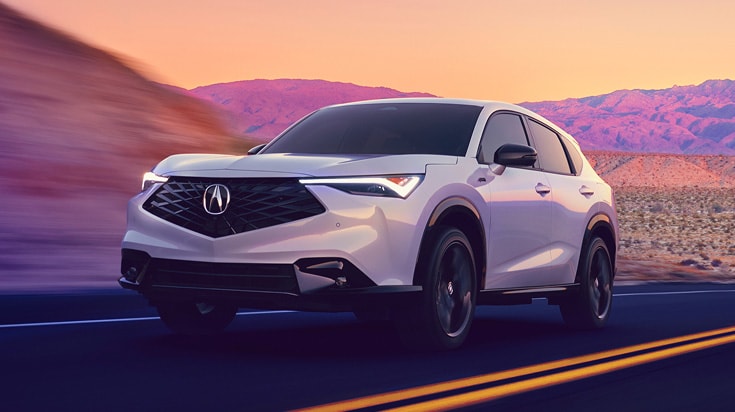 2026 Acura ADX A-Spec with Advance Package in Platinum White Pearl, front view, driving on a desert road at sunset (Premium Compact SUV). 2026 Acura ADX A-Spec with Advance Package in Platinum White Pearl, front view, driving on a desert road at sunset (Premium Compact SUV).