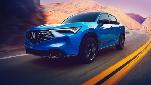 2026 Acura ADX A-Spec shown in Double Apex Blue Pearl II, driving on the road. 2026 Acura ADX A-Spec shown in Double Apex Blue Pearl II, driving on the road.