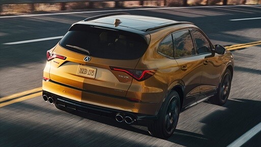 MDX rear 3/4 action shot in Tiger Eye Pearl