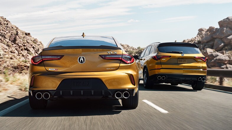 Acura MDX Type S Advance and TLX Type S in Tiger Eye Pearl rear view on the road