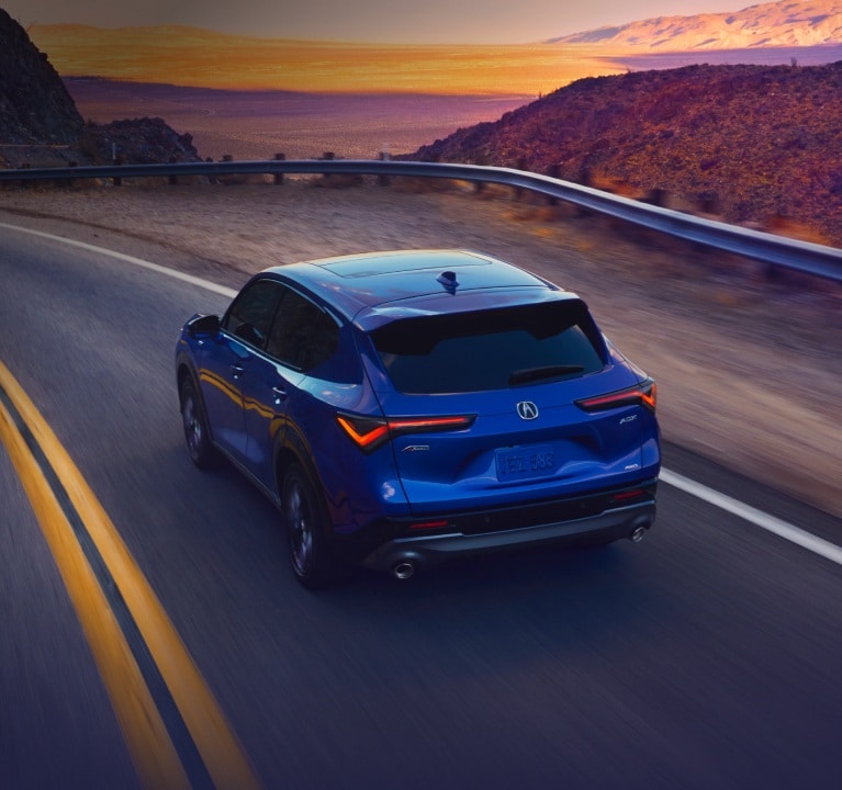 Acura 2025 ADX A-Spec with Advance Package in Adriatic Sea Blue Metallic rear view on the road