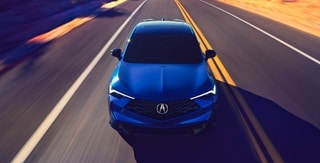 Acura 2025 ADX A-Spec with Advance Package in Adriatic Sea Blue Metallic front view on the road Acura 2025 ADX A-Spec with Advance Package in Adriatic Sea Blue Metallic front view on the road