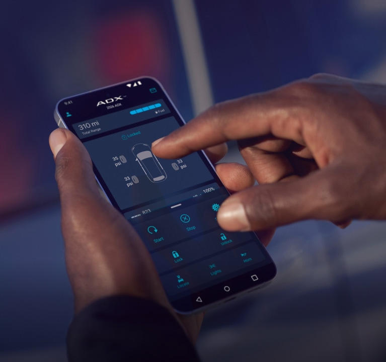 2026 Acura ADX close-up of a man’s hands using AcuraLink® connected services. (Premium Compact SUV).