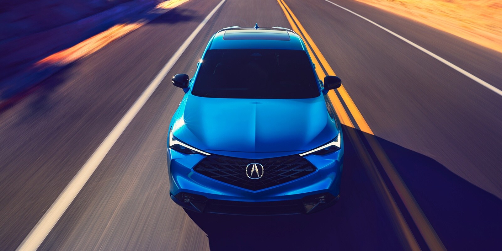 Blue 2026 Acura ADX A-SPEC driving on a road