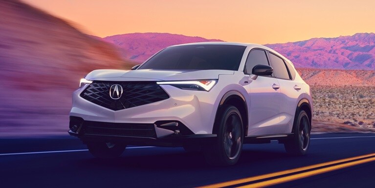 2026 Acura ADX A-Spec shown in Platinum White Pearl, driving on the road.