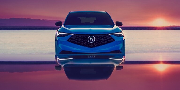 2026 Acura ADX A-Spec shown in Double Apex Blue Pearl II, parked with a sunset in the background.