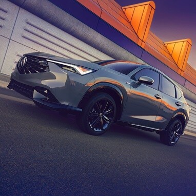 2026 Acura ADX A-Spec shown in Urban Gray Pearl, driving on the road.