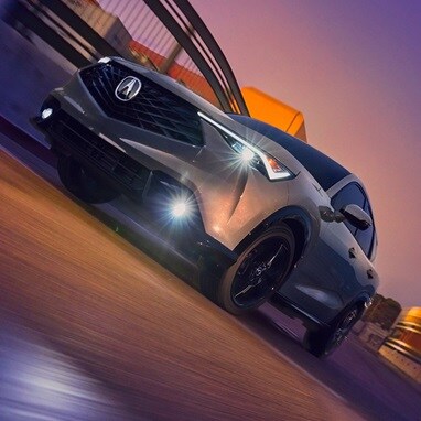 2026 Acura ADX A-Spec shown in Urban Gray Pearl, driving on the road.