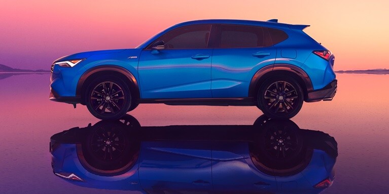 2026 Acura ADX A-Spec shown in Double Apex Blue Pearl II, parked with a sunset in the background.