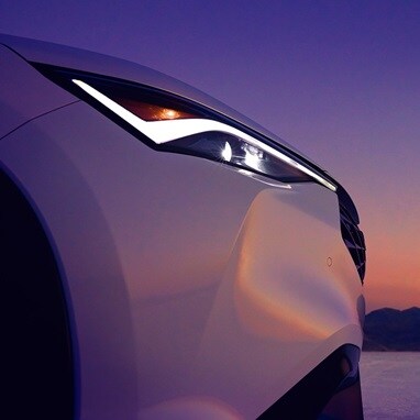 2026 Acura ADX A-Spec shown in Platinum White Pearl, parked with a sunset in the background.