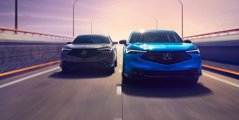 2026 Acura ADX A-Spec shown in Urban Gray Pearl and ADX A-Spec with Advance Package in Double Apex Blue Pearl II, driving on the road.