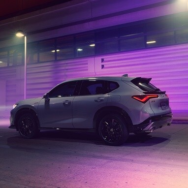 2026 Acura ADX A-Spec shown in Urban Gray Pearl, driving on the road.