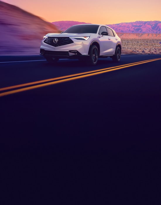 2026 Acura ADX A-Spec shown in Platinum White Pearl, driving on the road.