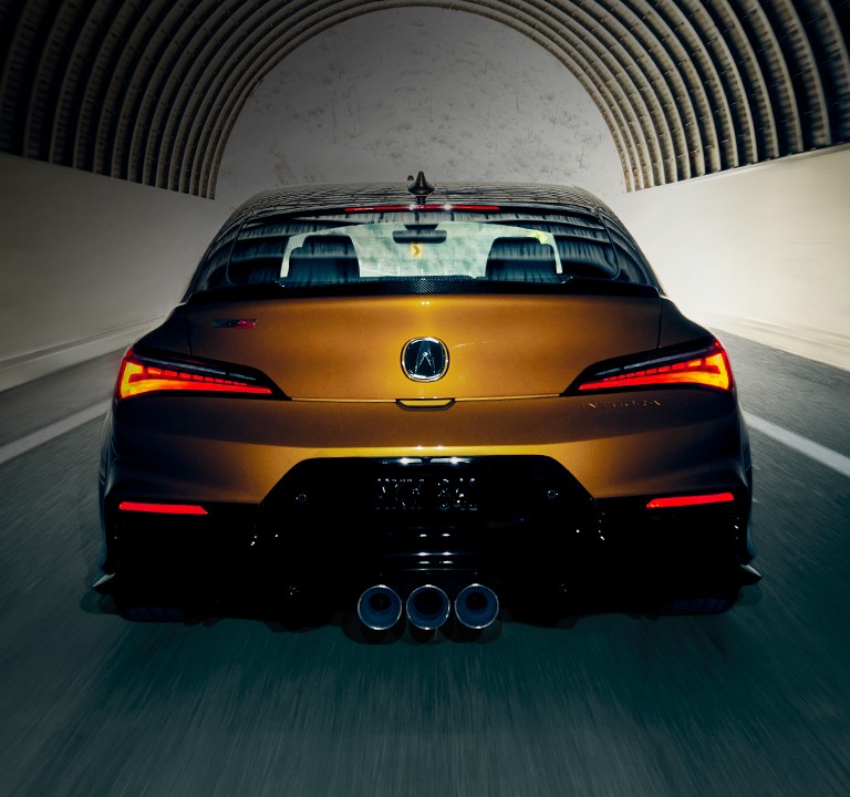 2024 Integra Type S in Tiger Eye Pearl, rear view, driving through a tunnel