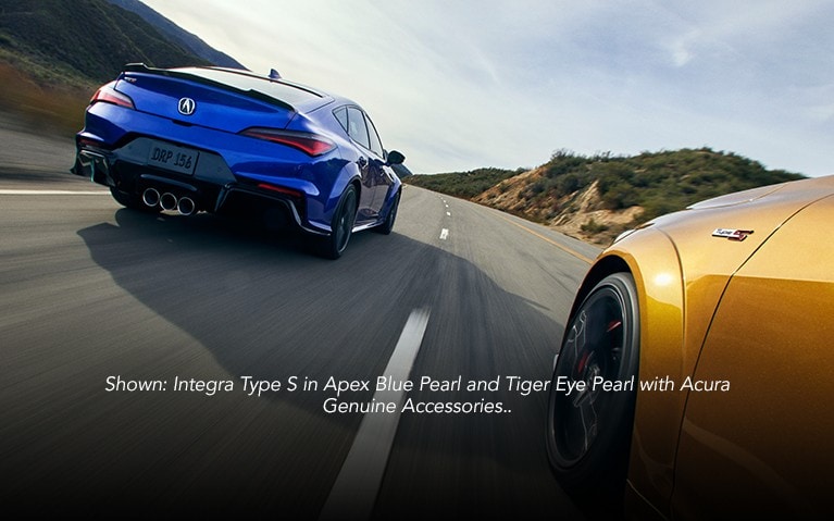 Acura Integra Type S in Apex Blue Pearl and Tiger Eye Pearl on the road.