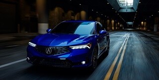 2025 Integra 3/4 front view driving in Apex Blue Pearl