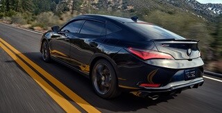 2025 Integra rear view driving on the road