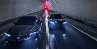 Two 2025 Integra driving in a tunnel, top front view