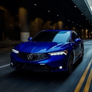 2025 Integra 3/4 front view driving in Apex Blue Pearl