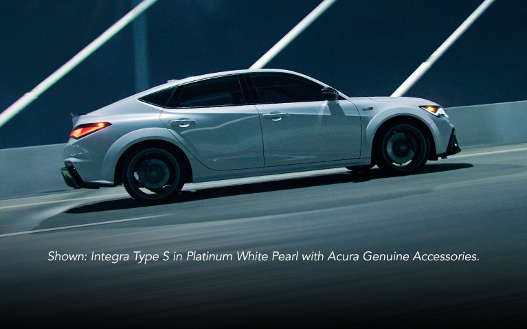Acura Integra Type S profile in Platinum White Pearl crossing a bridge.