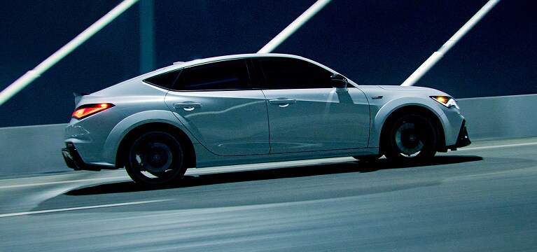 2026 Acura Integra Type S shown in Platinum White Pearl on a Bridge at night