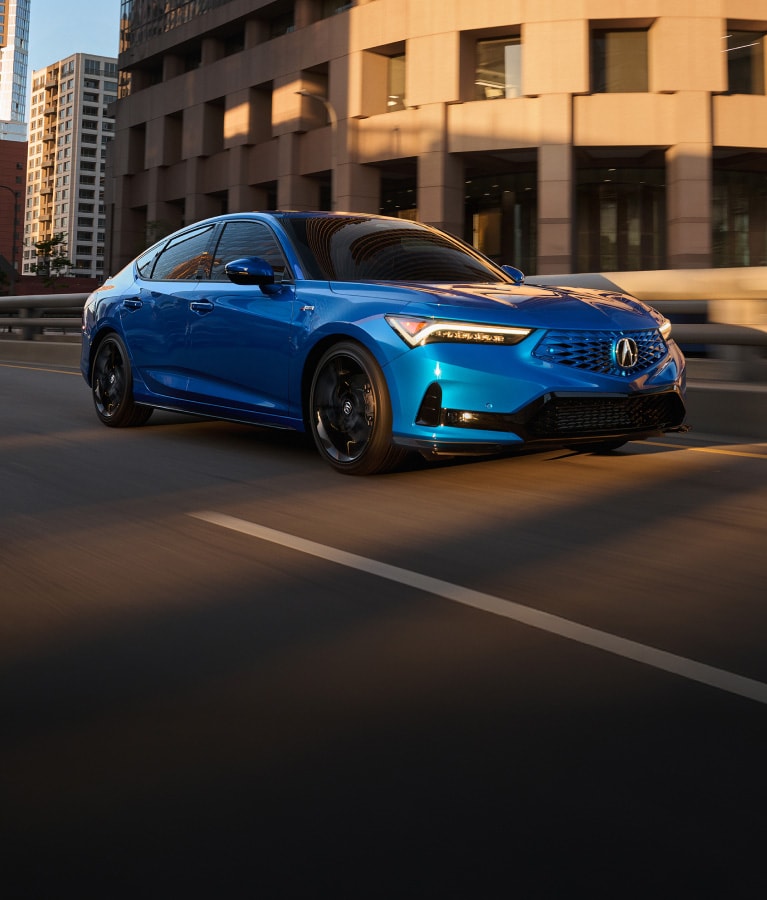 2026 Acura Integra A-Spec with Technology Package shown in Double Apex Blue Pearl, driving across the city.