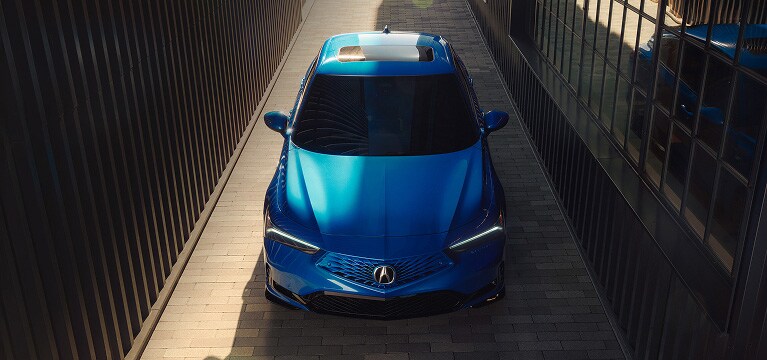 2026 Acura Integra A-Spec with Technology Package shown in Double Apex Blue Pearl, parked outside a modern building.