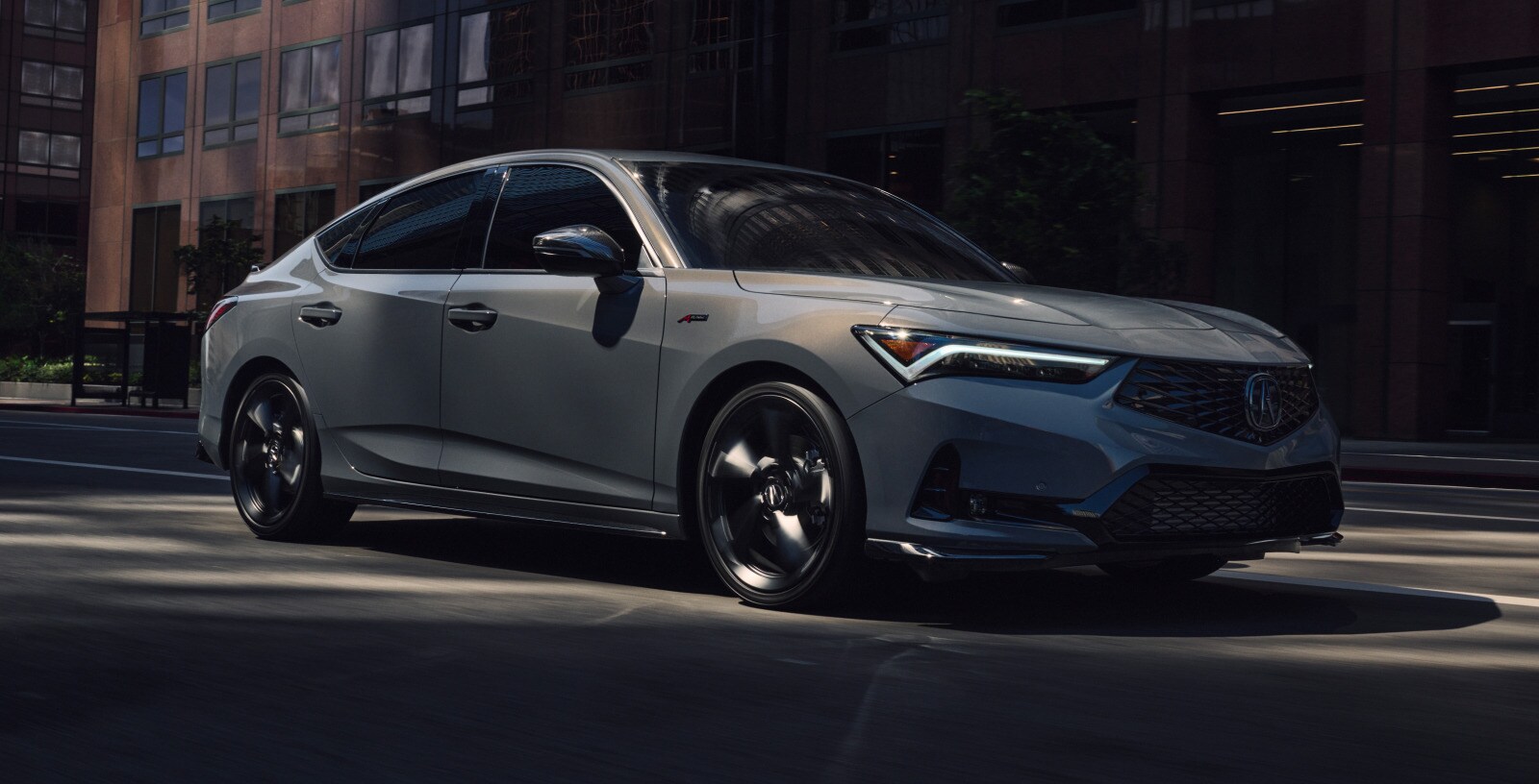 Acura Integra premium sport compact driving through the city