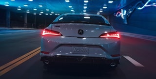 2026 Acura Integra in Urban Gray Pearl, rear view driving in a tunnel. 2026 Acura Integra in Urban Gray Pearl, rear view driving in a tunnel.