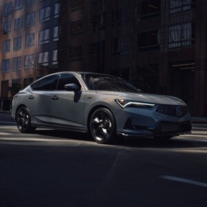 2026 Acura Integra 3/4 front view driving in Urban Gray Pearl. 2026 Acura Integra 3/4 front view driving in Urban Gray Pearl.