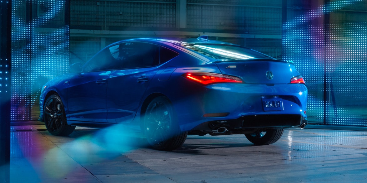 2026 Acura Integra A-Spec with Technology Package in Double Apex Blue Pearl rear three-quarter view.