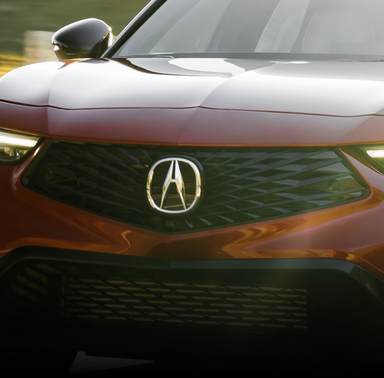 2026 Acura Integra shown in Performance Red Pearl featuring the Front Grille