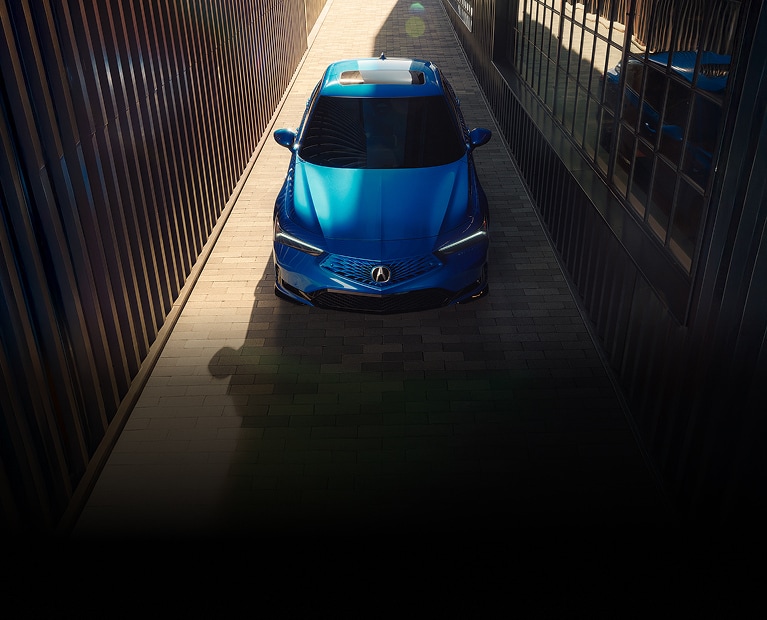 2026 Acura Integra A-Spec with Technology Package in Double Apex Blue Pearl top parked in an alleyway (Premium Sport Compact). 2026 Acura Integra A-Spec with Technology Package in Double Apex Blue Pearl top parked in an alleyway (Premium Sport Compact).