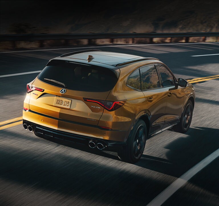 2024 Acura MDX Type S Advance Tiger Eye Pearl rear view in the street