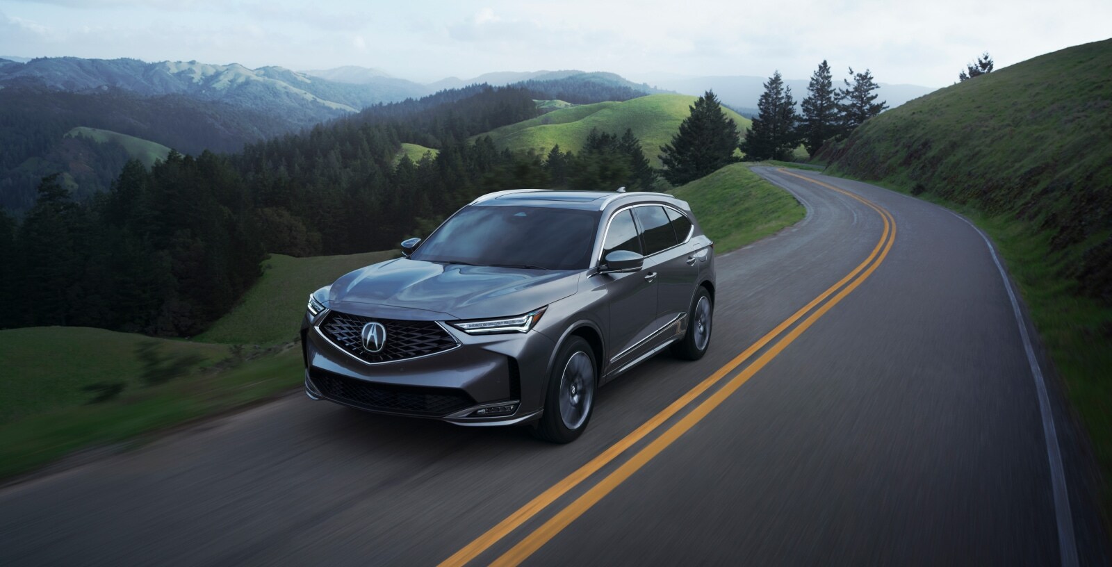 Acura MDX premium performance SUV driving on a mountain road