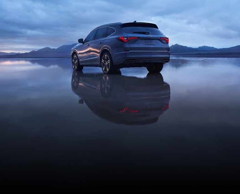 2026 Acura MDX with Advance Package in Liquid Carbon Metallic back with a dramatic reflection (Premium Performance SUV). 2026 Acura MDX with Advance Package in Liquid Carbon Metallic back with a dramatic reflection (Premium Performance SUV).