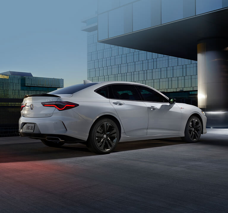 Acura 2023 TLX A-Spec® in front of modern building at night