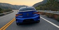 2025 Acura TLX A-Spec Package in Apex Blue Pearl rear view on the road.