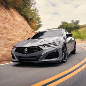 2025 Acura TLX Type S in Urban Gray Pearl 3/4 front view on the road.